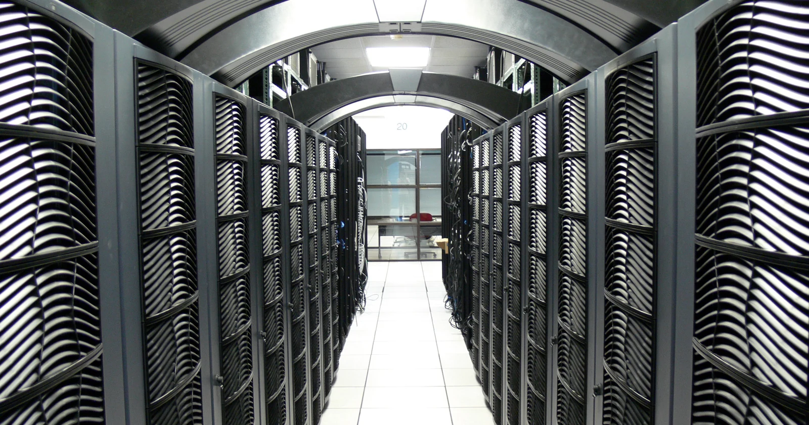Rows of server cabinets along a data center aisle
