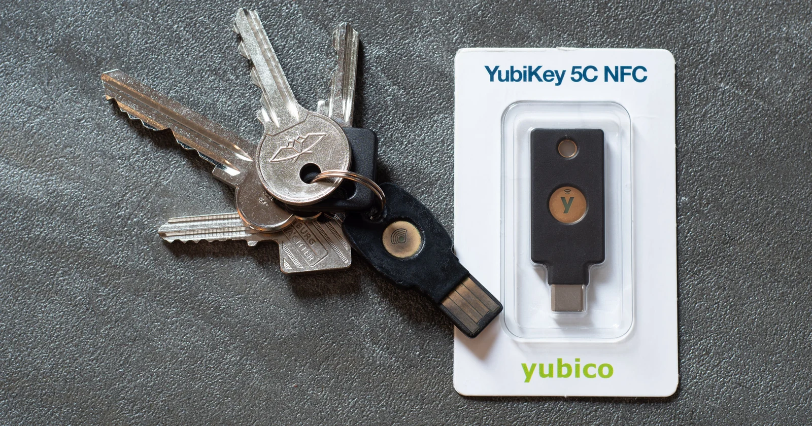 Hardware security key beside a set of physical keys