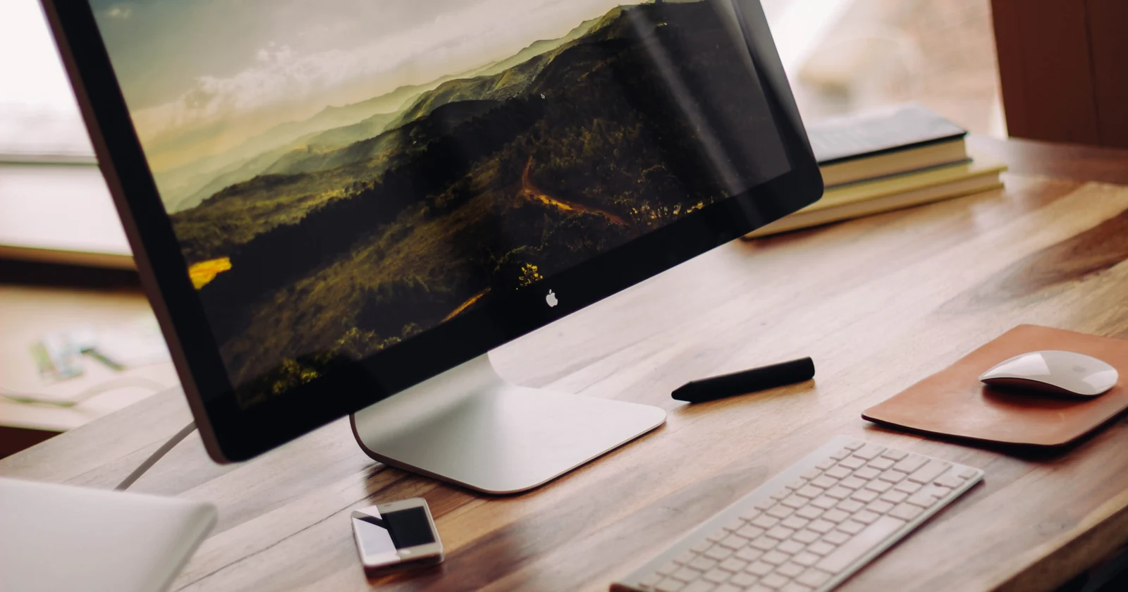 Desktop computer with keyboard and mouse on a wooden desk