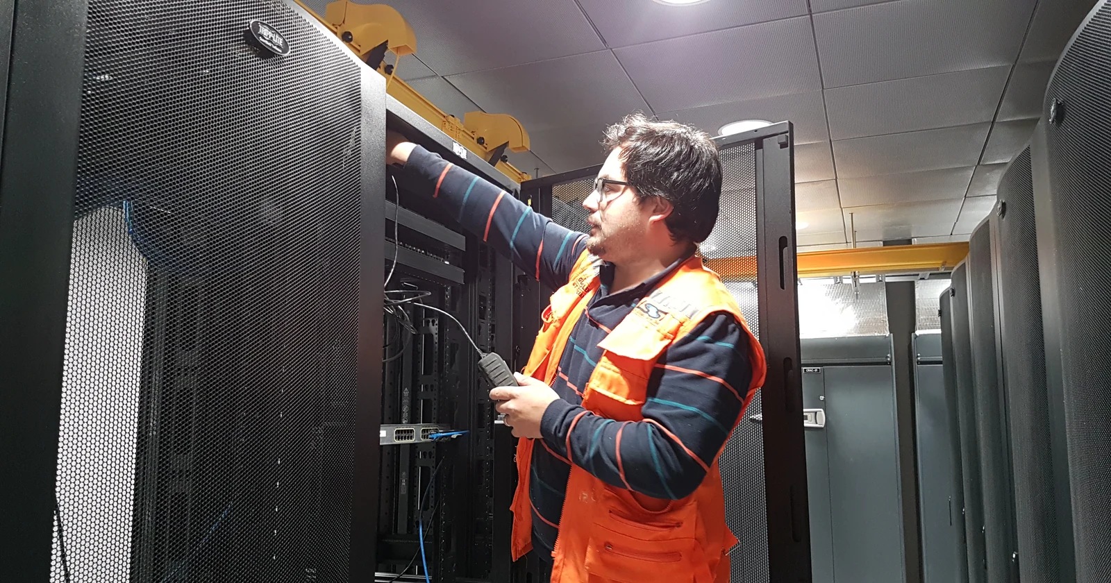Technician installing equipment inside a server cabinet