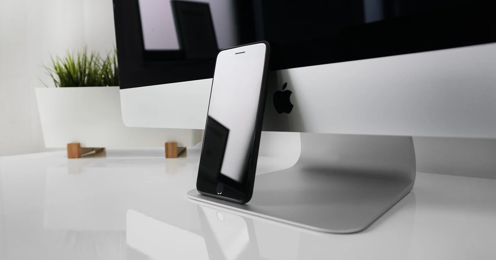 Smartphone beside a desktop computer