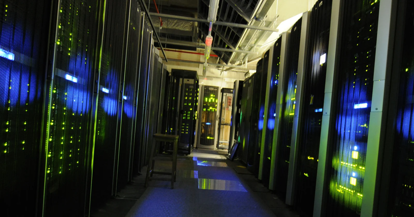 Server cabinets and overhead cabling along a data center aisle