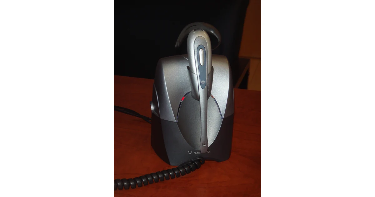 Office headset in its charging base