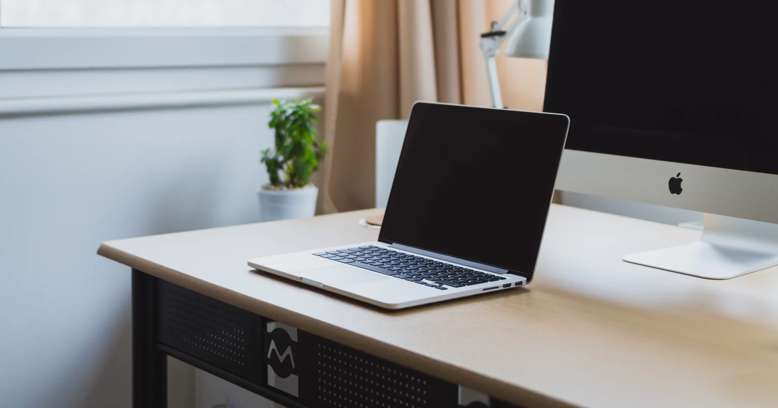 Laptop and desktop computer in a tidy workspace