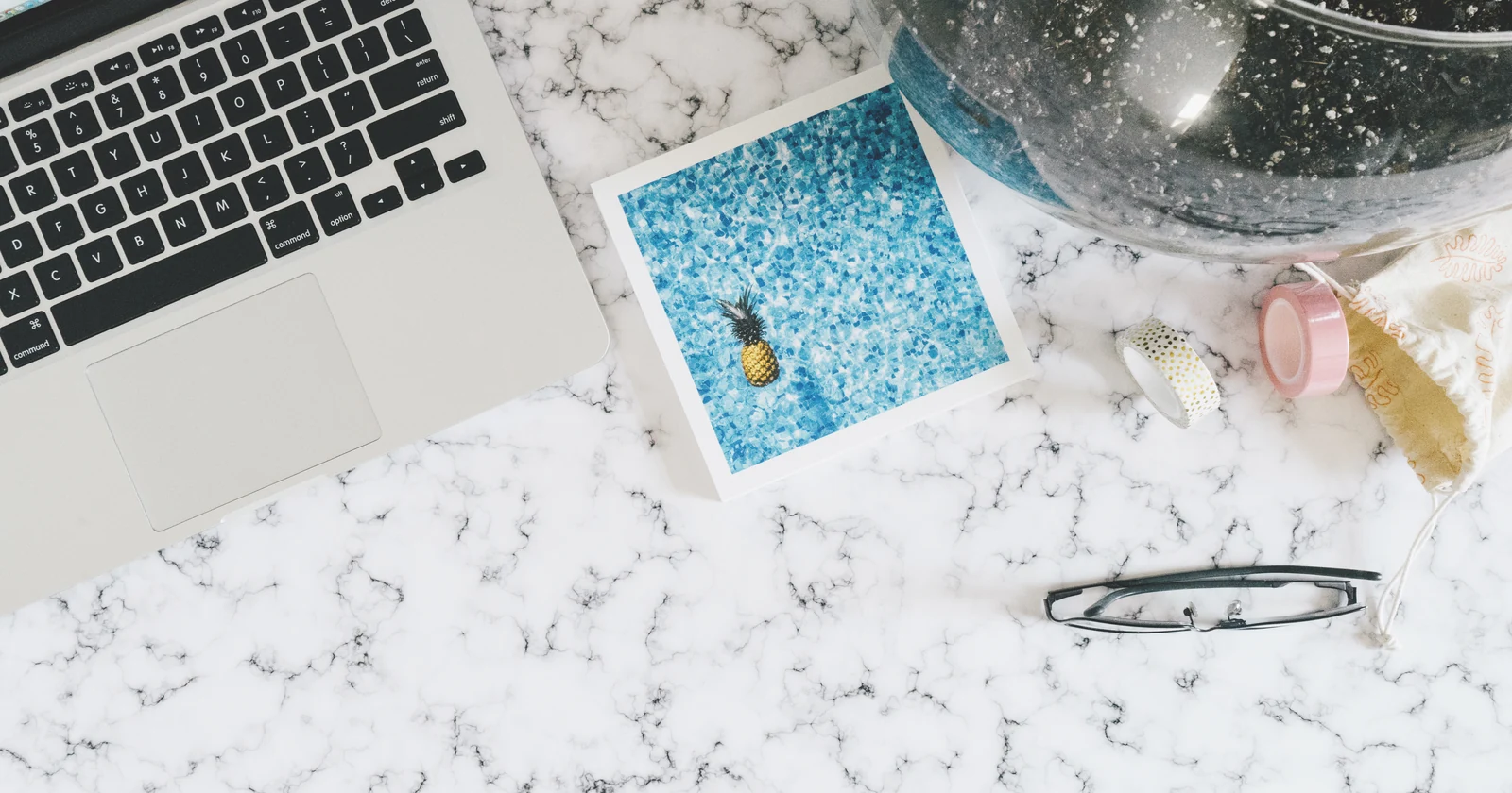 Laptop and planning materials on a marble desk