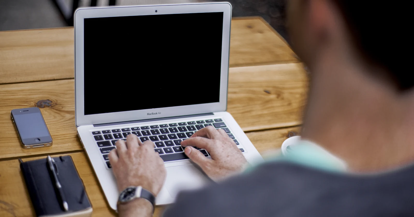 Person typing on a laptop at a table