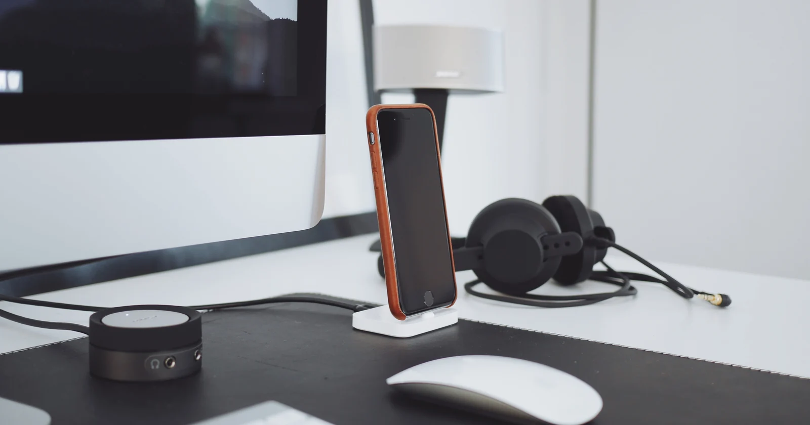 Computer peripherals and headphones on a work desk