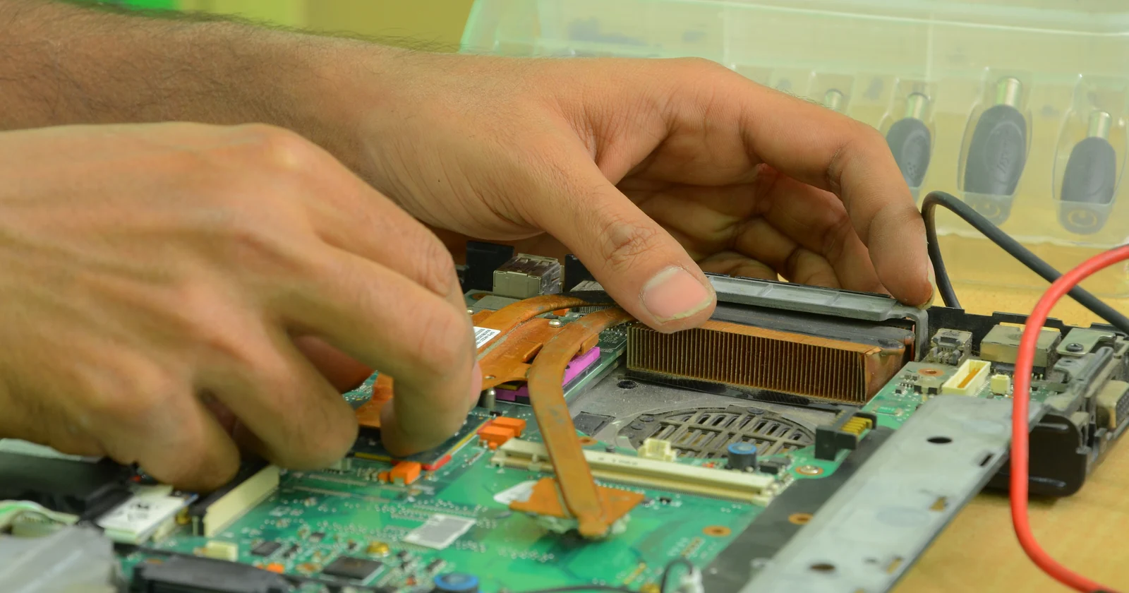 Hands working on the components inside a computer