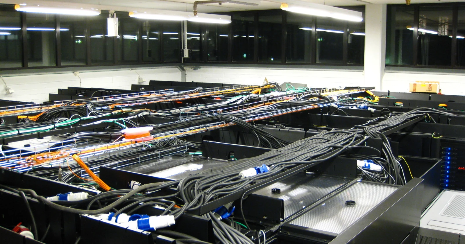 Rows of servers with structured cabling in a computing facility