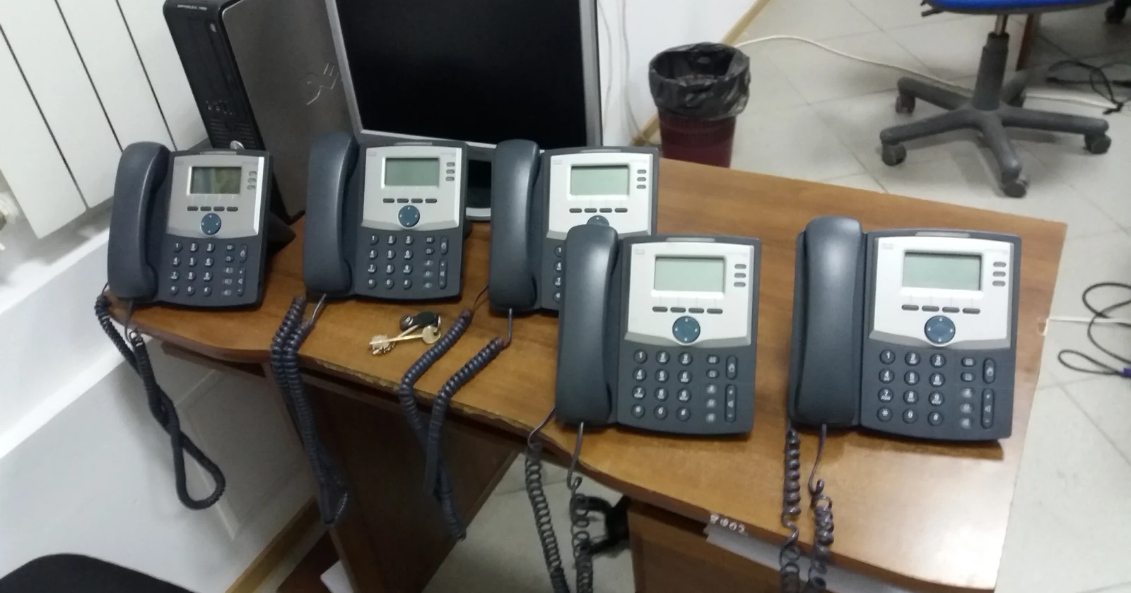 Several business IP desk phones arranged together