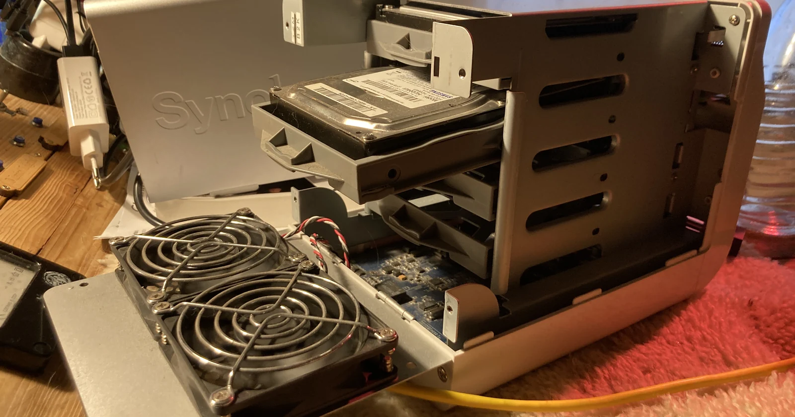 Opened network attached storage unit with cooling fan and drive bays